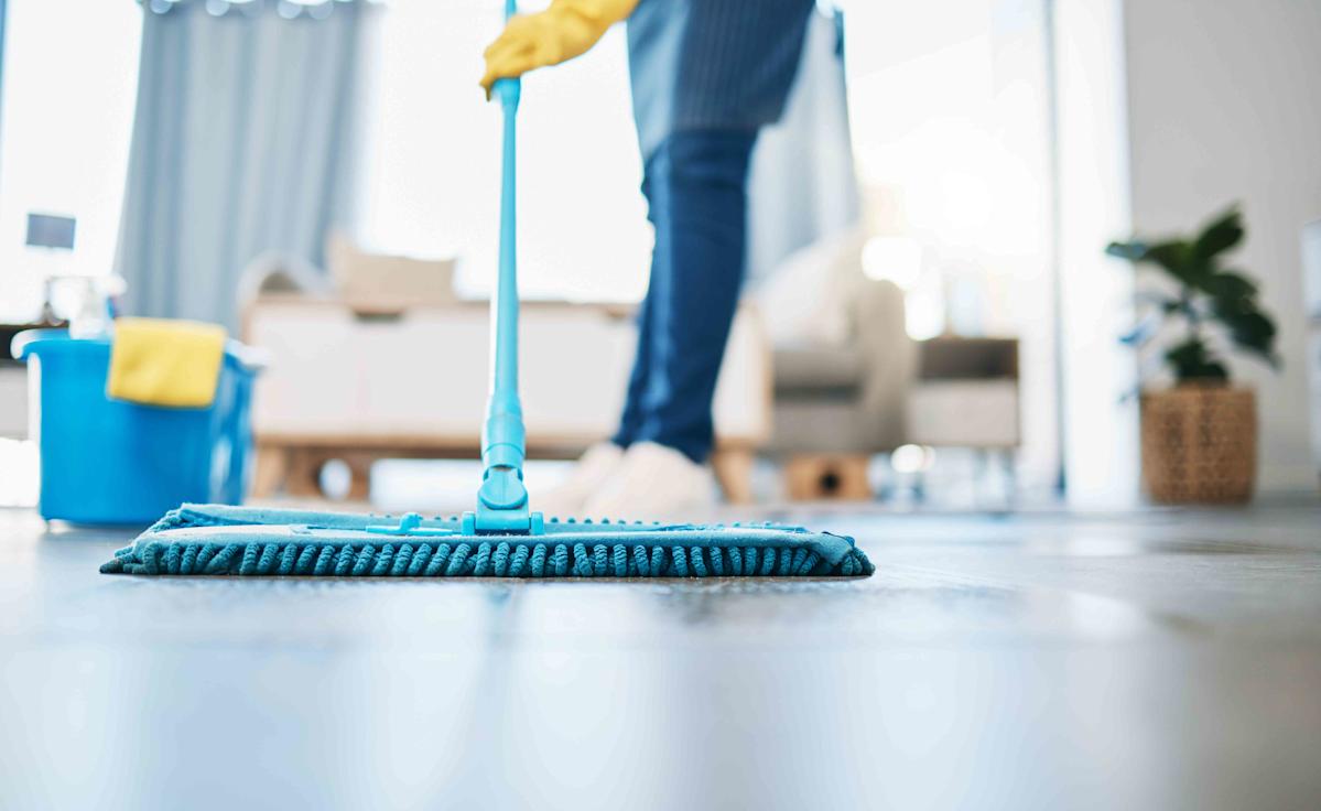 Person Mopping Floor in Clean Indoor Space